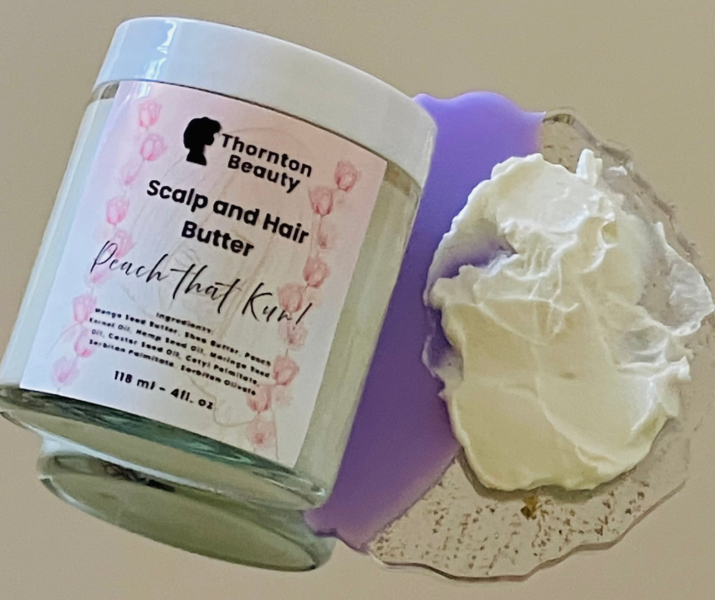 Thornton Beauty Scalp and Hair Butter with a sample on a textured surface