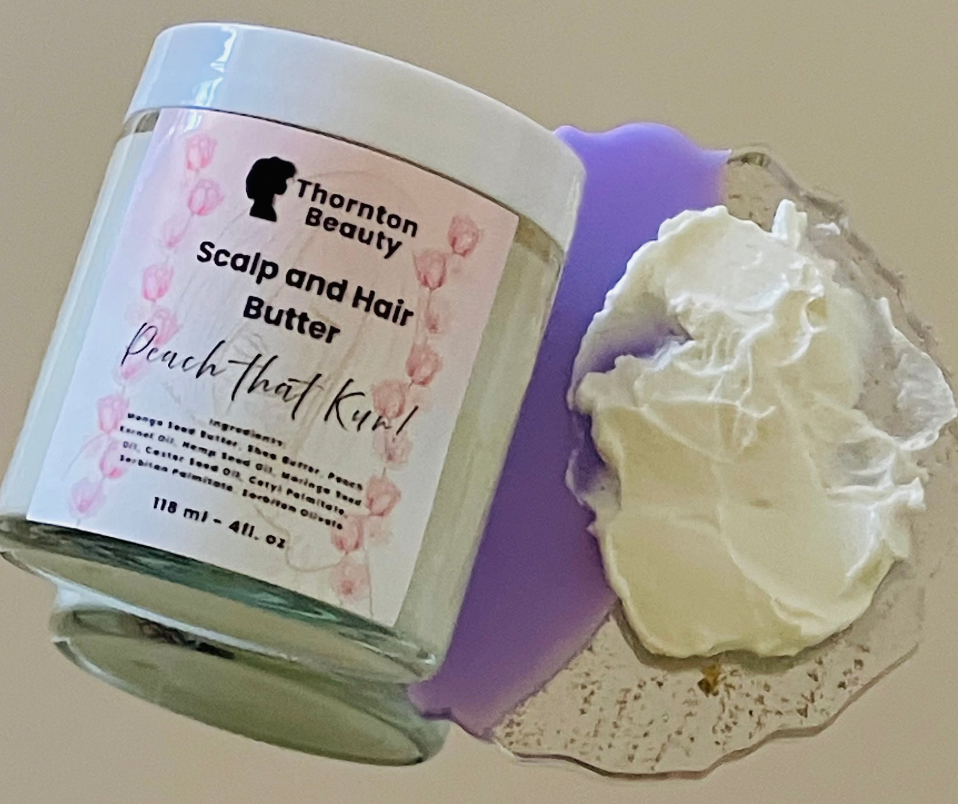 Thornton Beauty Scalp and Hair Butter with a sample on a textured surface